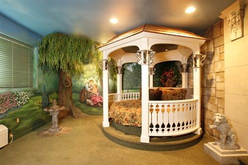 A bedroom with a gazebo and a painting on the wall